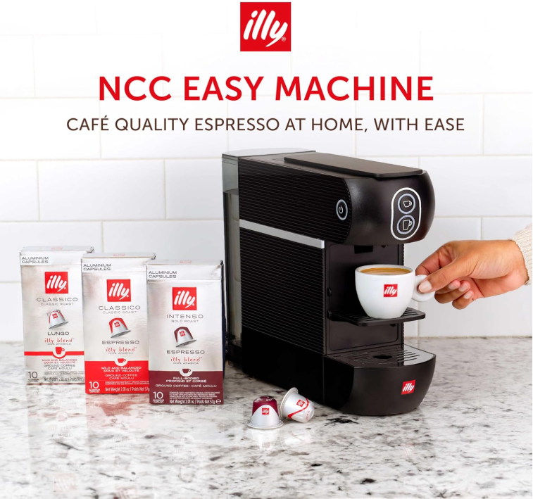 Espresso capsule being inserted into the Illy machine's top-loading slot
