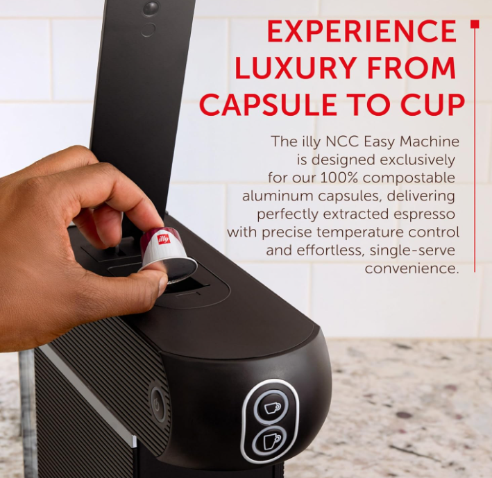 Compact Illy espresso machine next to a coffee mug for scale