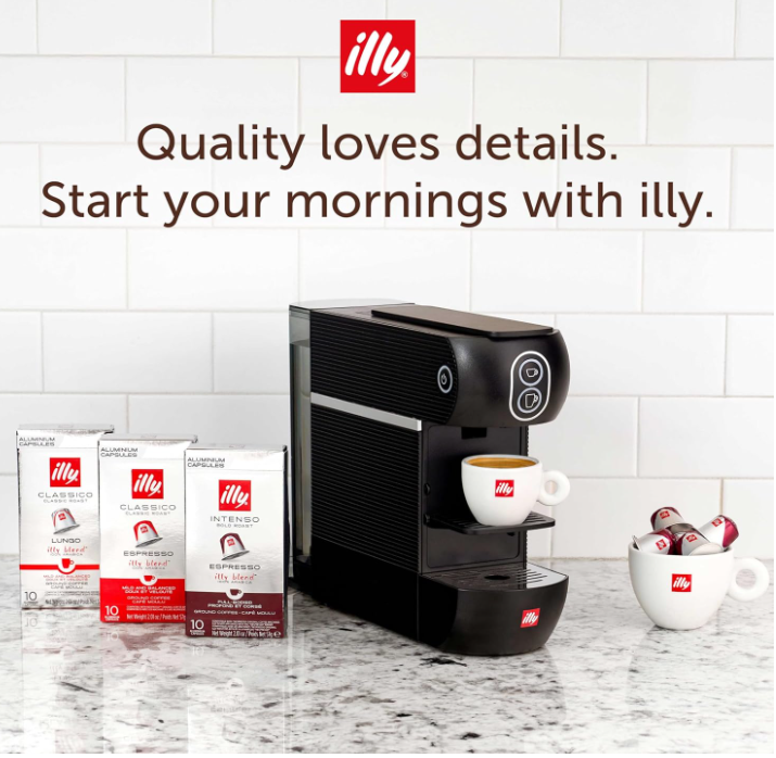 Illy capsules placed beside the compact home espresso machine
