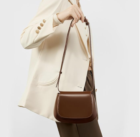 Woman wearing a leather crossbody mini bag while walking in the city