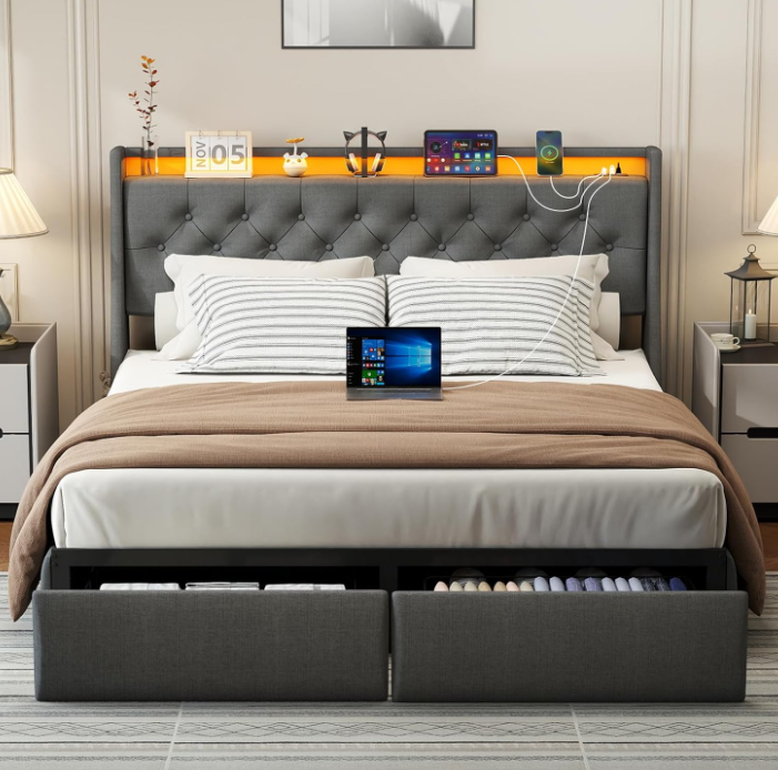 Side view of Doltoro full size bed showing 2-tier headboard storage shelf with books and phone, and built-in charging station ports on a gray upholstered platform bed