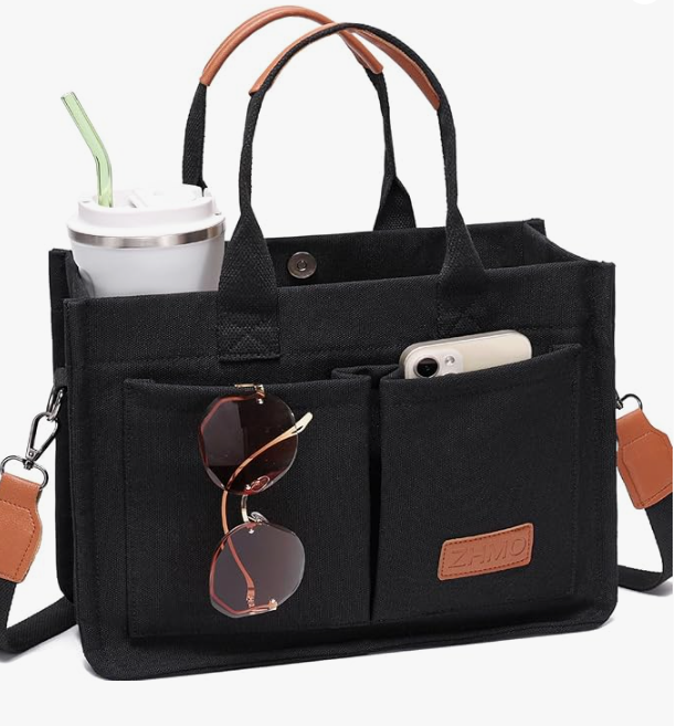 Canvas tote bag interior packed with laptop, books, and water bottle showing large capacity